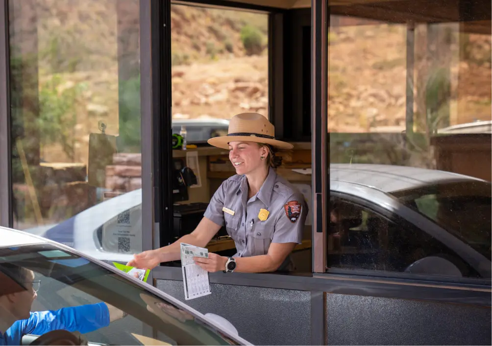 A park ranger admitting a guest into the park
