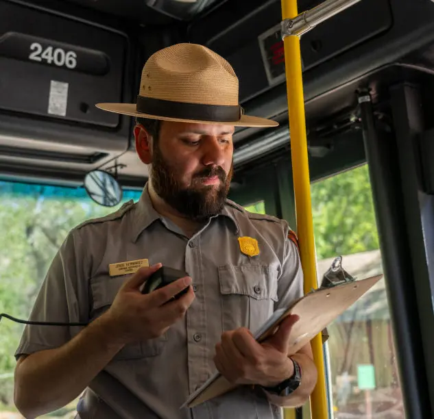 A park ranger giving a tour on a bus