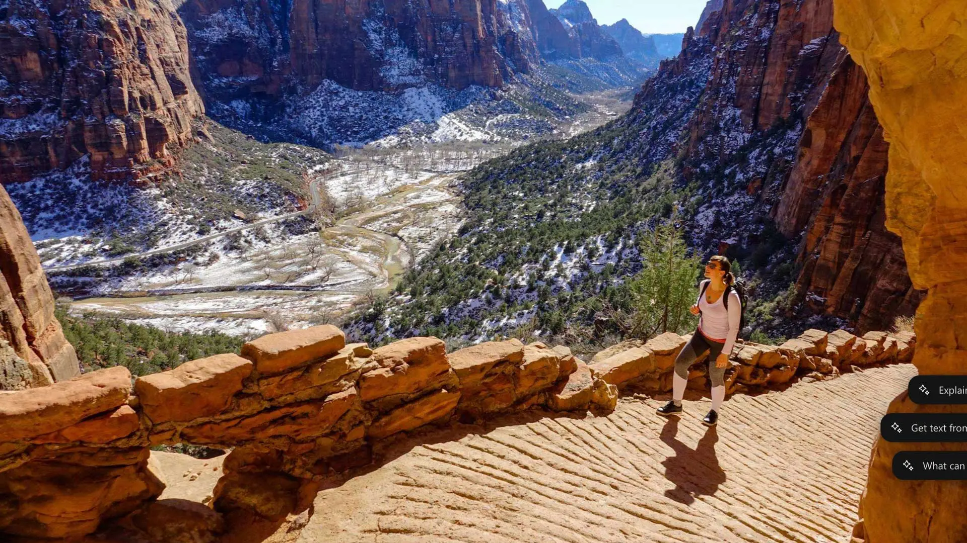 a woman walks up angels landing in the winter